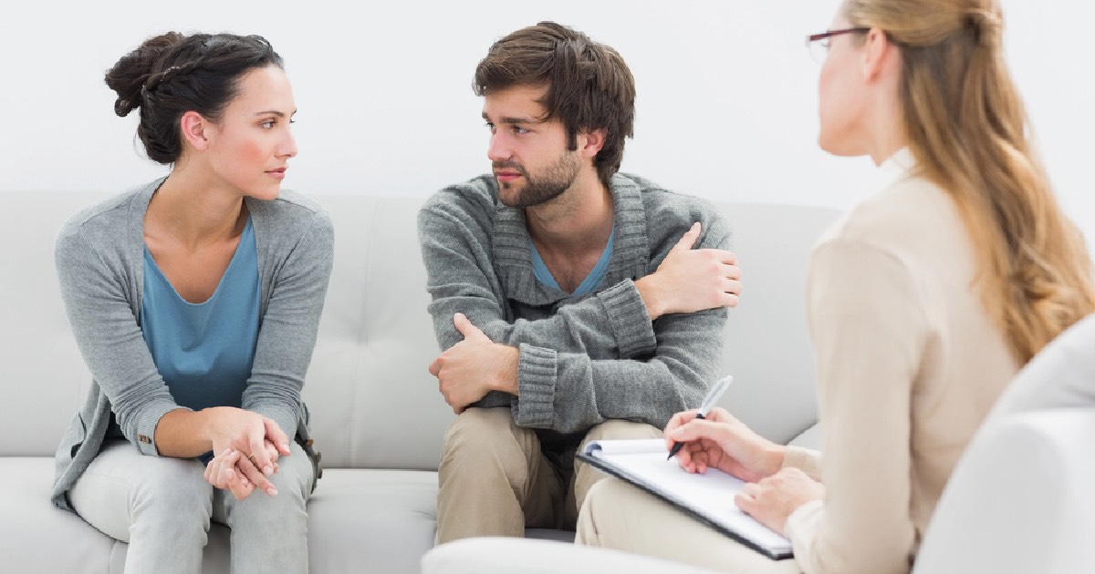 Couple sitting in therapy with a therapist 