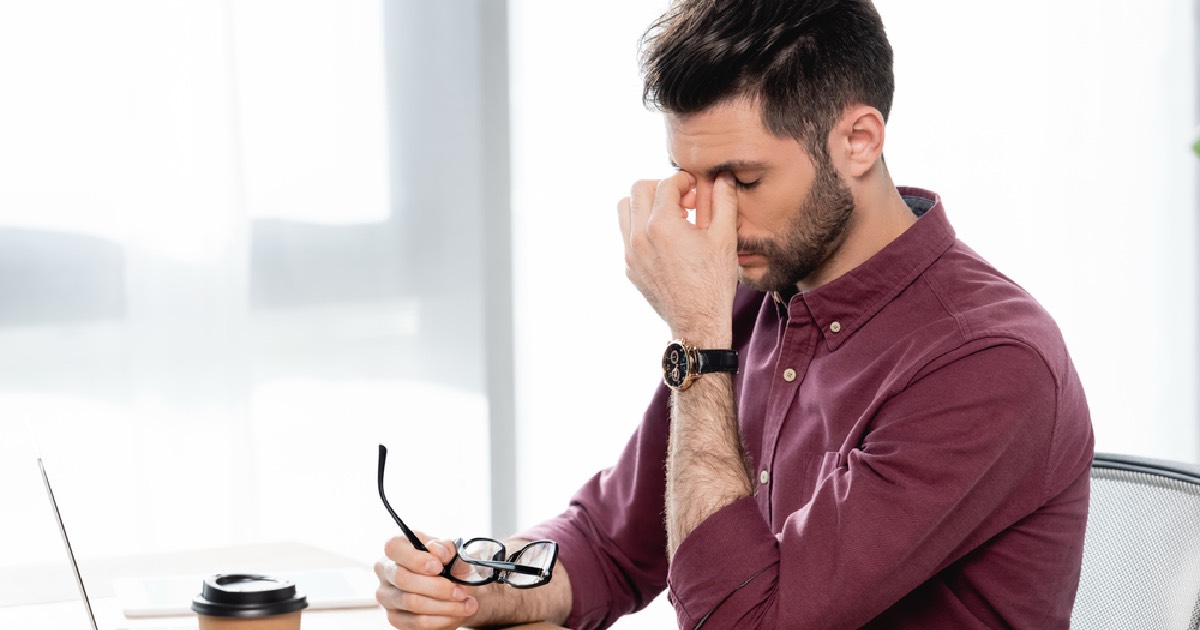Business professional feeling tired at work 