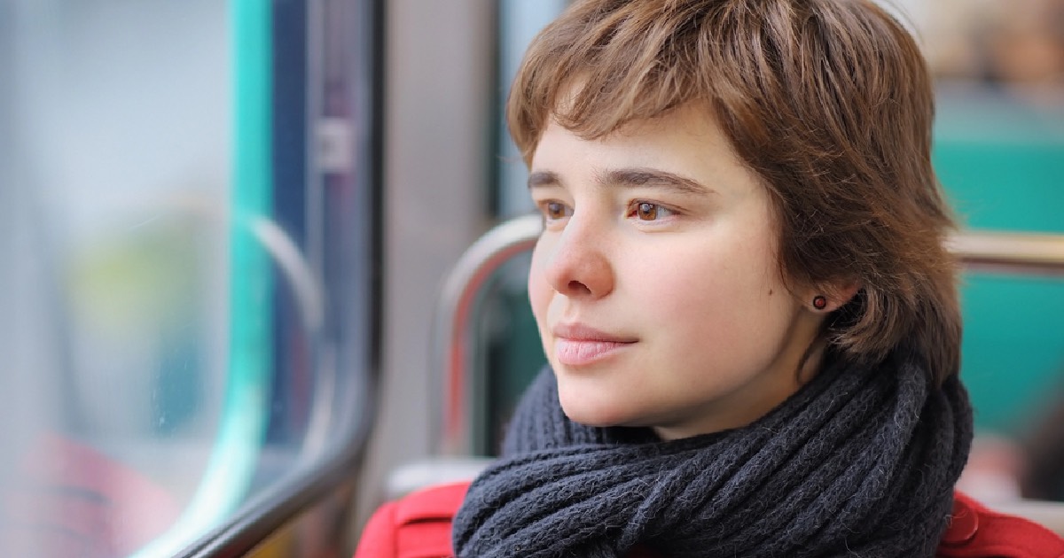 Young woman sitting on public transportation 