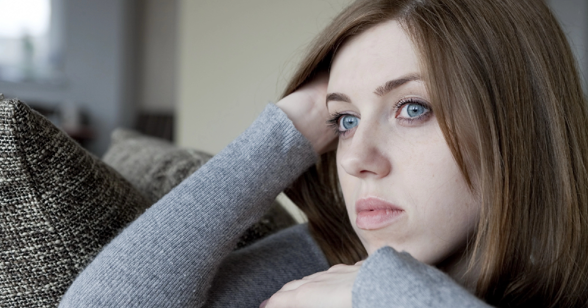 Tired looking woman with bright blue eyes