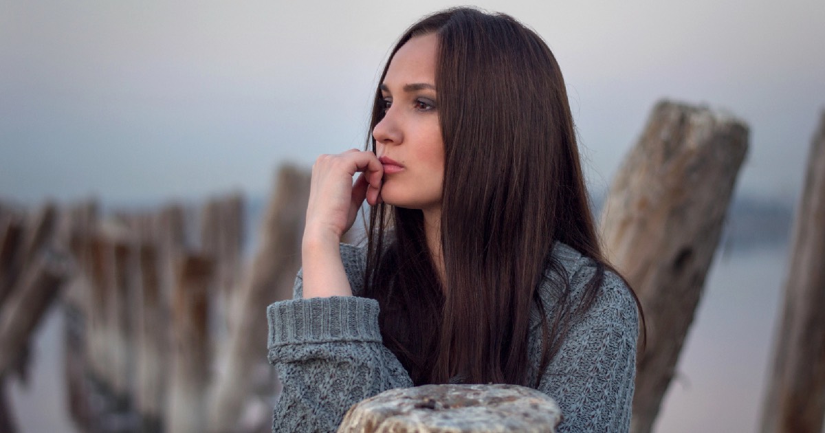 Melancholy woman sitting outside 