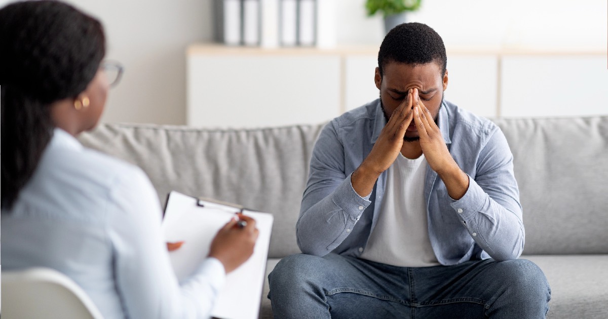 Man sitting with therapist discussing trauma